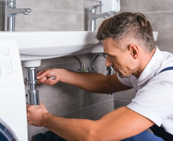 adult-plumber-fixing-sink-at-bathroom
