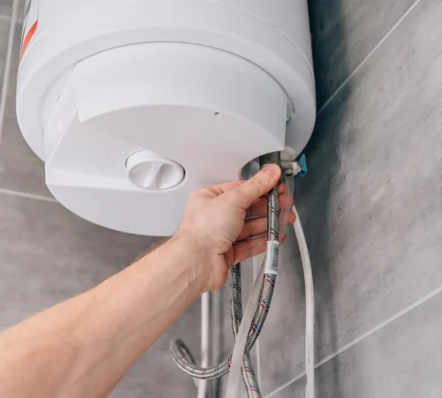 cropped-shot-of-male-plumber-repairing-electric-boiler-in-bathroom